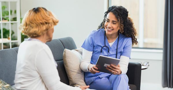 Female doctor discussing digital tools with female patient